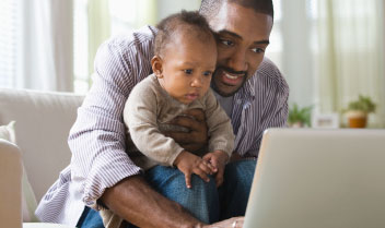 Father and son looking at computer